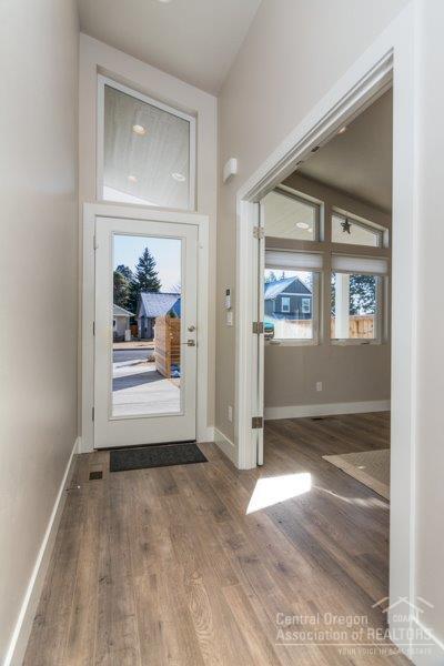 62013 Dantili Road Bend, OR 97701 - Photo 4 of 25 an empty room with window and wooden floor