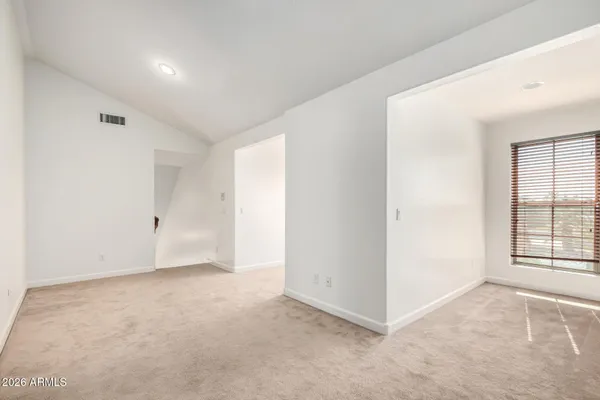 an empty room with windows and closet