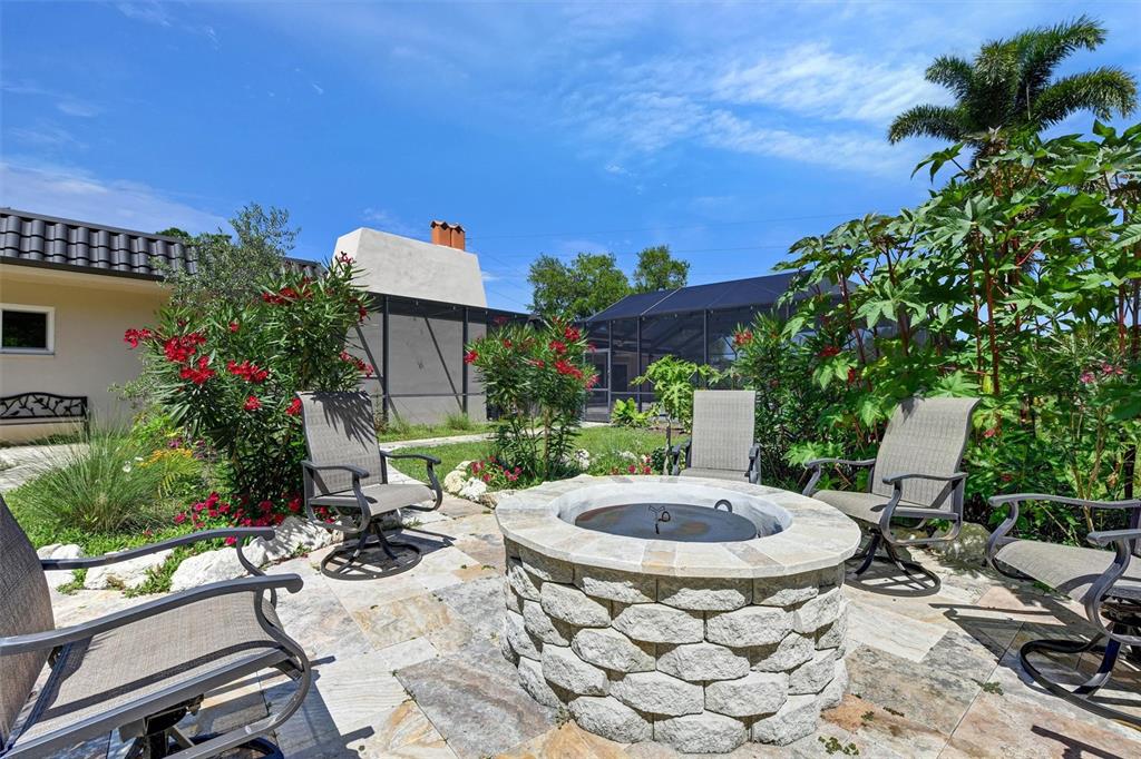 1875 Belleair Road Clearwater, FL 33764 - Photo 69 of 100 a view of a patio with table and chairs potted plants with wooden fence