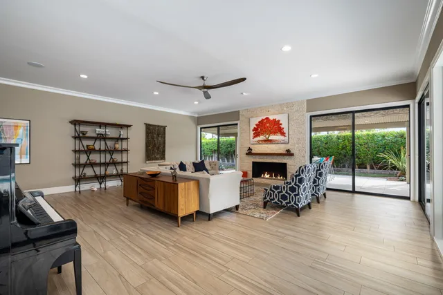 a living room with fireplace furniture and a wooden floor