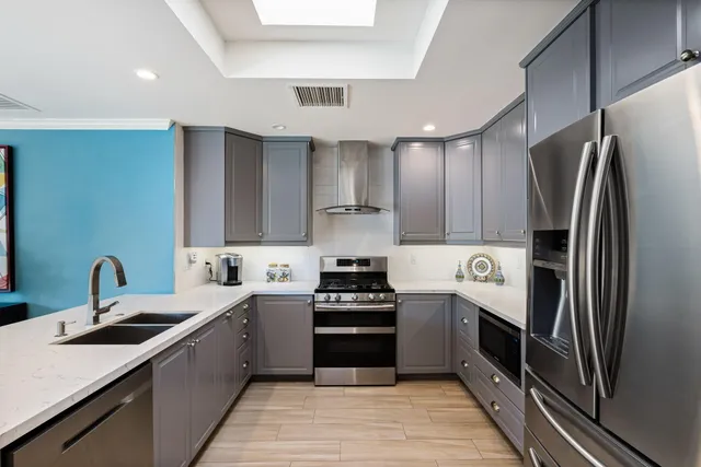 a kitchen with a sink stainless steel appliances and cabinets