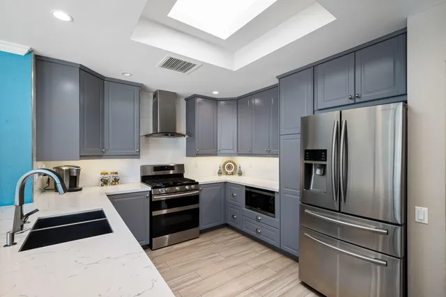 a kitchen with a refrigerator sink and stove