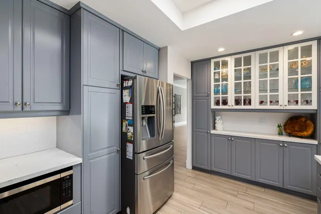 a kitchen with stainless steel appliances a refrigerator and a sink
