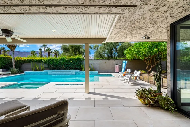 a view of a patio with a table and chairs