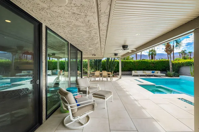 a view of a patio with chairs and tables