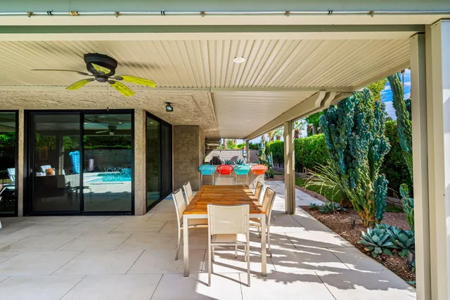 a dining room with furniture and garden view