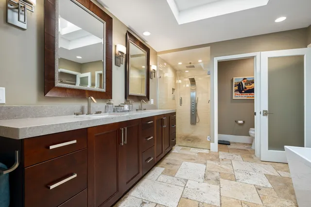 a spacious bathroom with a tub sink and glass door