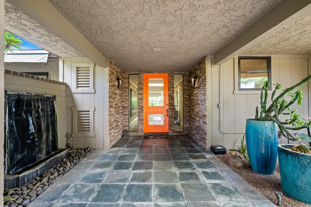 a room with window and potted plants