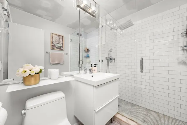 a bathroom with a sink toilet and mirror