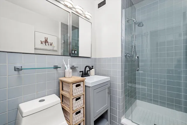 a bathroom with a sink a toilet and a shower