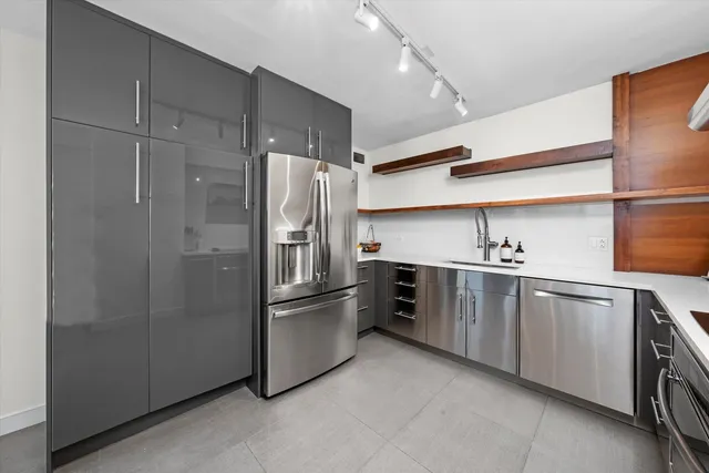 a kitchen with stainless steel appliances a refrigerator and a sink