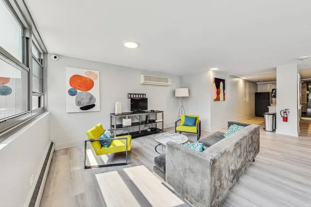 a living room with furniture and flat screen tv