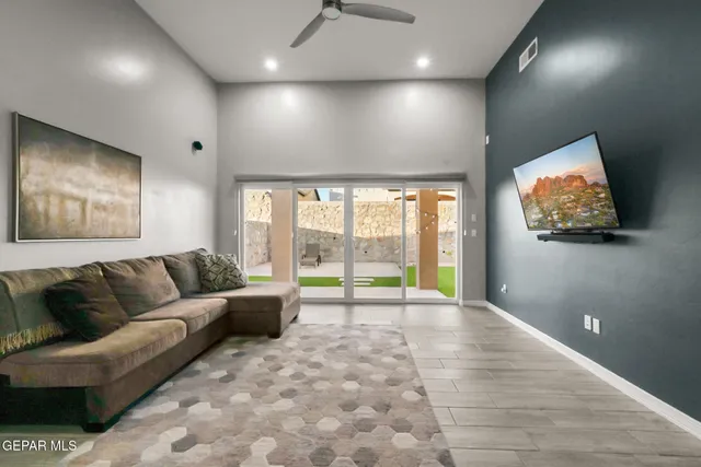 a room with stainless steel appliances kitchen island granite countertop a sink a stove and a refrigerator