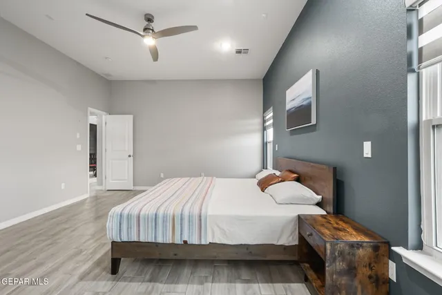 a bathroom with a granite countertop sink a toilet and a mirror
