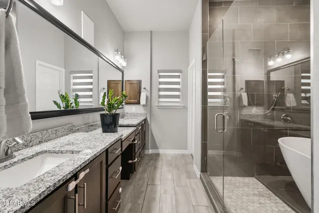 a bathroom with a granite countertop sink a toilet and shower