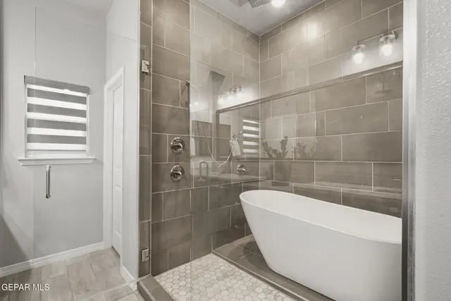 a spacious bathroom with a granite countertop sink a toilet a mirror and shower