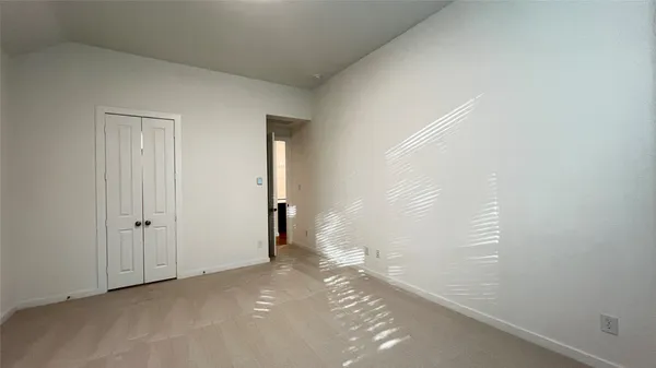a view of a big room with closet and wooden door
