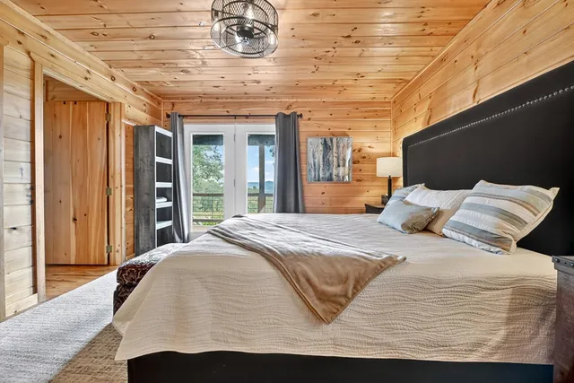 a bed sitting in a bedroom next to a window