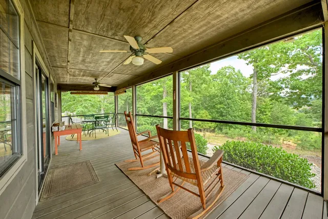a view of a porch with furniture and wooden floor