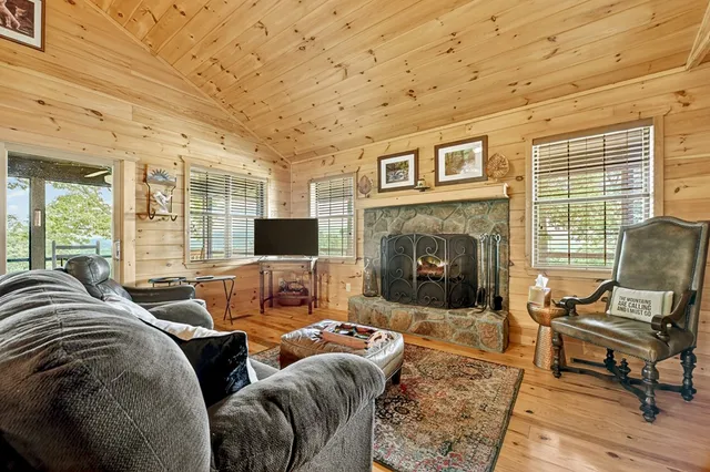 a living room with furniture large window and a fireplace