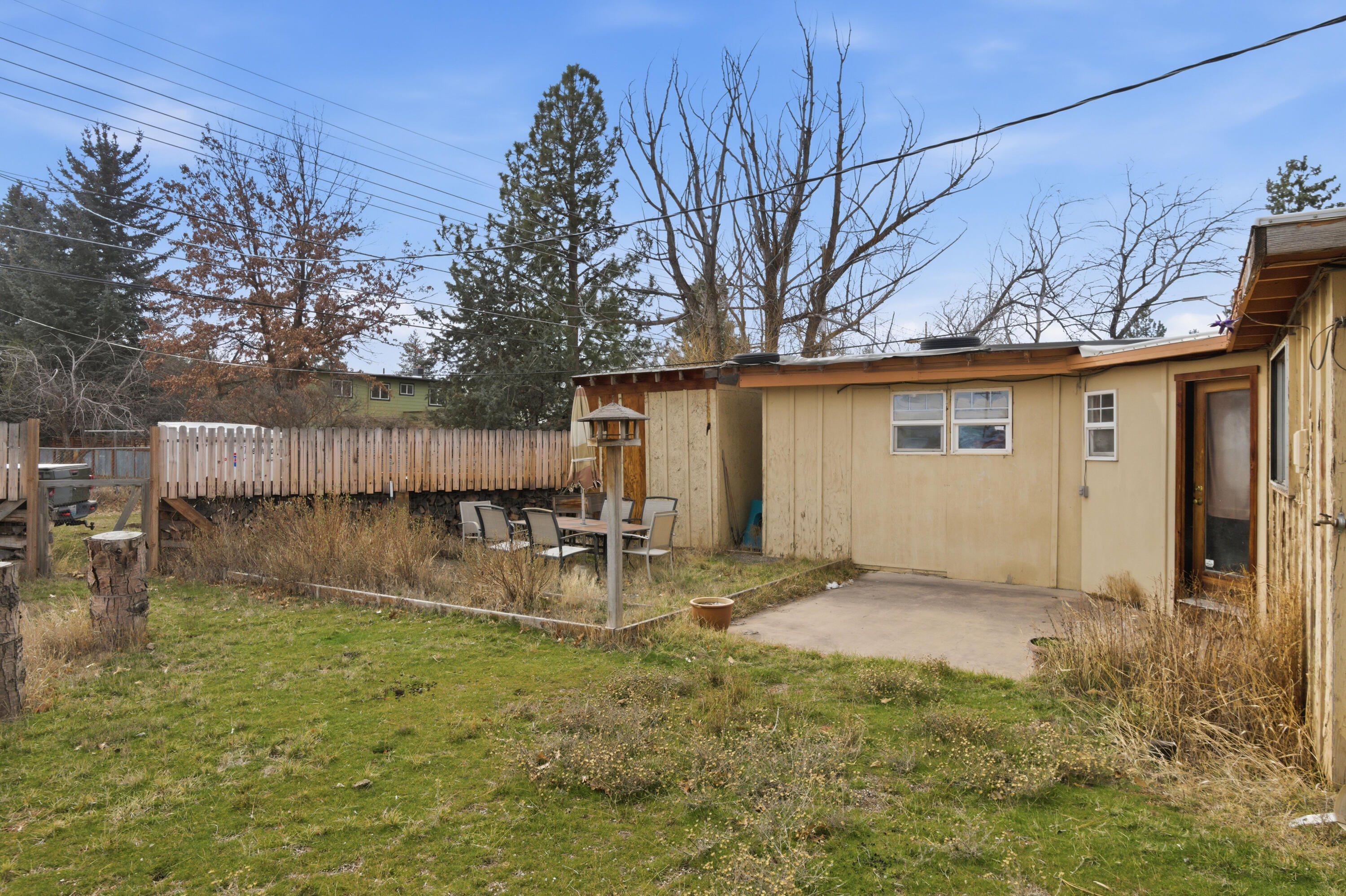 243 West Adams Avenue Sisters, OR 97759 - Photo 13 of 19 a backyard of a house with table and chairs