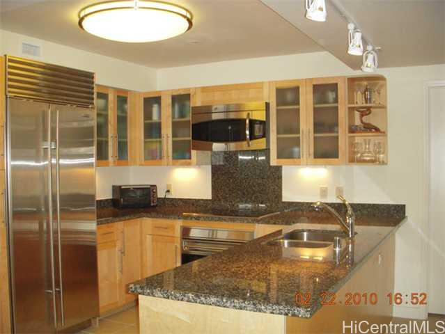 600 Queen Street, Unit 1603 Honolulu, HI 96813 - Photo 1 of 1 a kitchen with granite countertop a stove a sink and a refrigerator