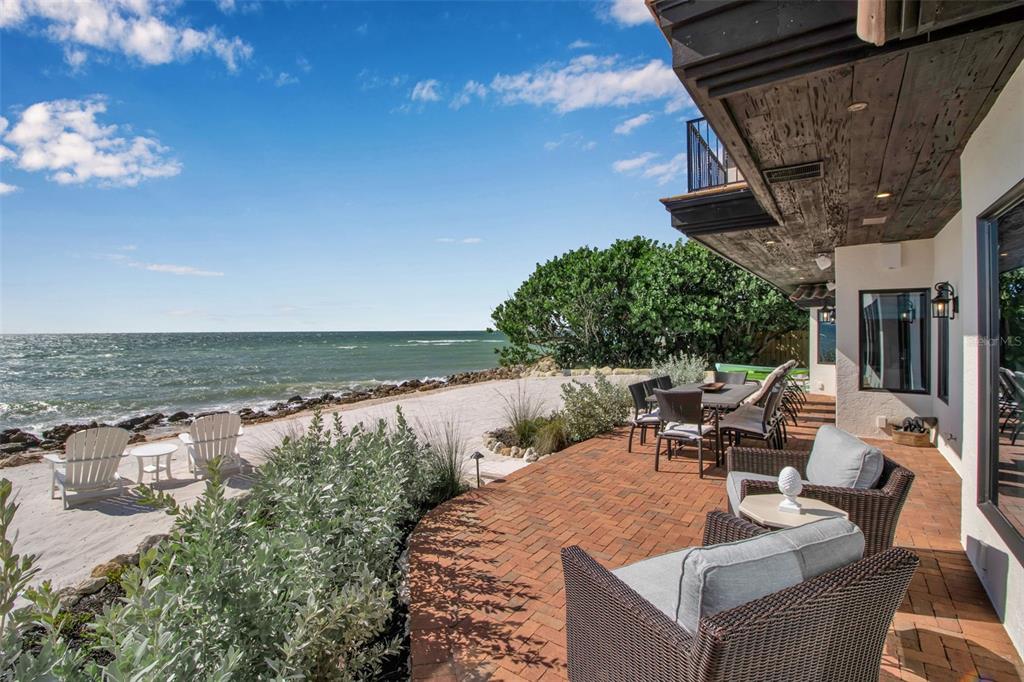 121 North Casey Key Road Osprey, FL 34229 - Photo 18 of 63 an outdoor space with patio furniture and potted plants