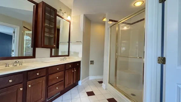 a living room with stainless steel appliances kitchen island granite countertop a sink and a large mirror