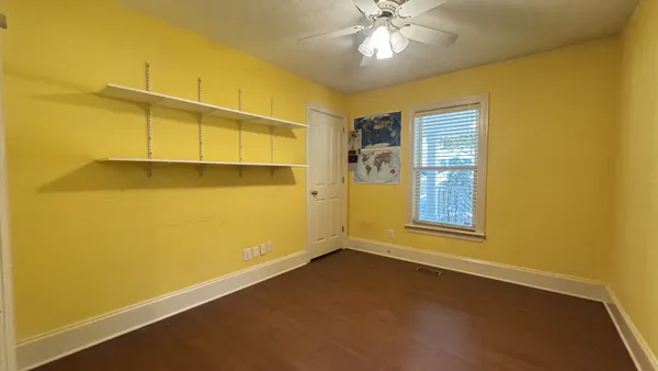 a open kitchen with stainless steel appliances granite countertop a refrigerator a sink dishwasher a stove and a dining table with wooden floor