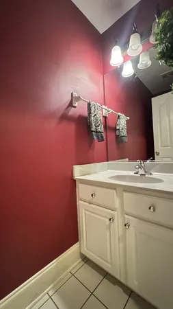 a kitchen with granite countertop a stove a sink and a wooden cabinets