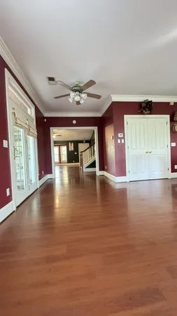 a open kitchen with stainless steel appliances granite countertop a refrigerator a sink dishwasher a stove and a dining table with wooden floor
