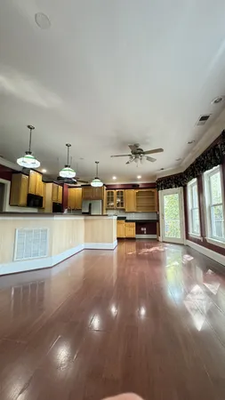 an empty room with windows and fireplace