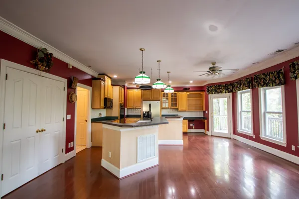a open kitchen with a refrigerator stove top oven and cabinets