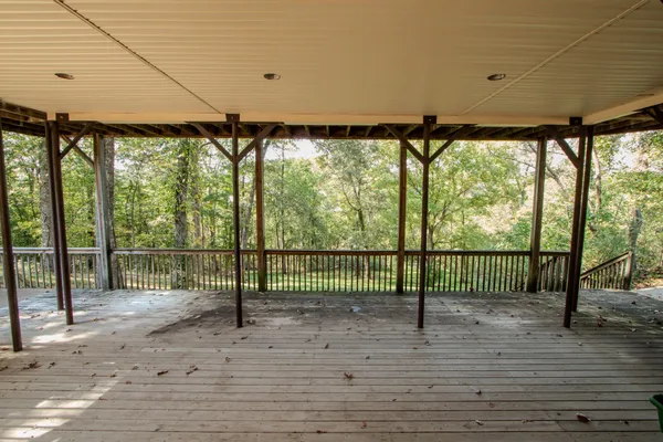 a view of outdoor space with wooden floor and windows