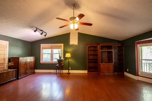a view of a livingroom with an empty space and a window