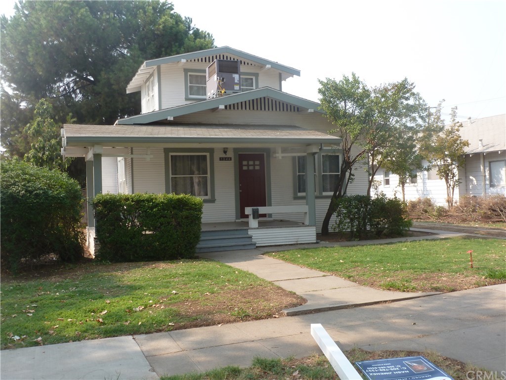 a view of a house with a patio and a yard