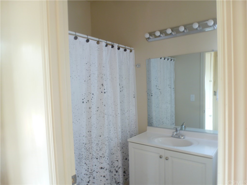 1044 West 20th Street Merced, CA 95340 - Photo 12 of 25 a bathroom with a sink a toilet and shower