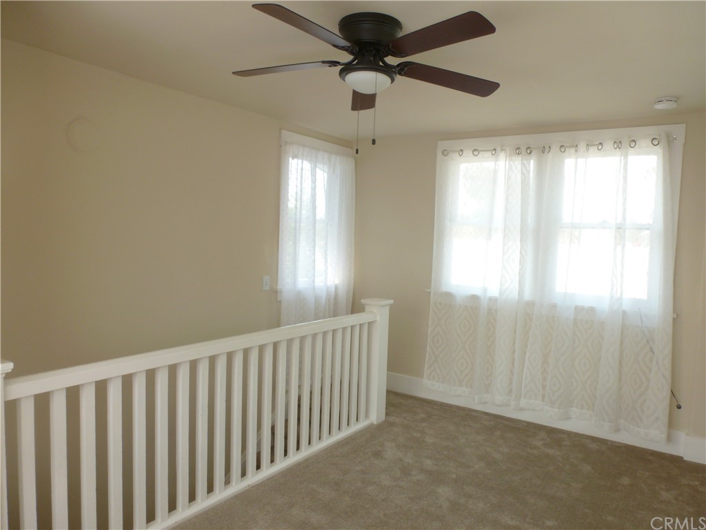 1044 West 20th Street Merced, CA 95340 - Photo 16 of 25 a view of entryway with a window and a chandelier fan
