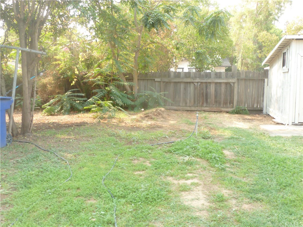 1044 West 20th Street Merced, CA 95340 - Photo 23 of 25 a view of a yard with wooden fence