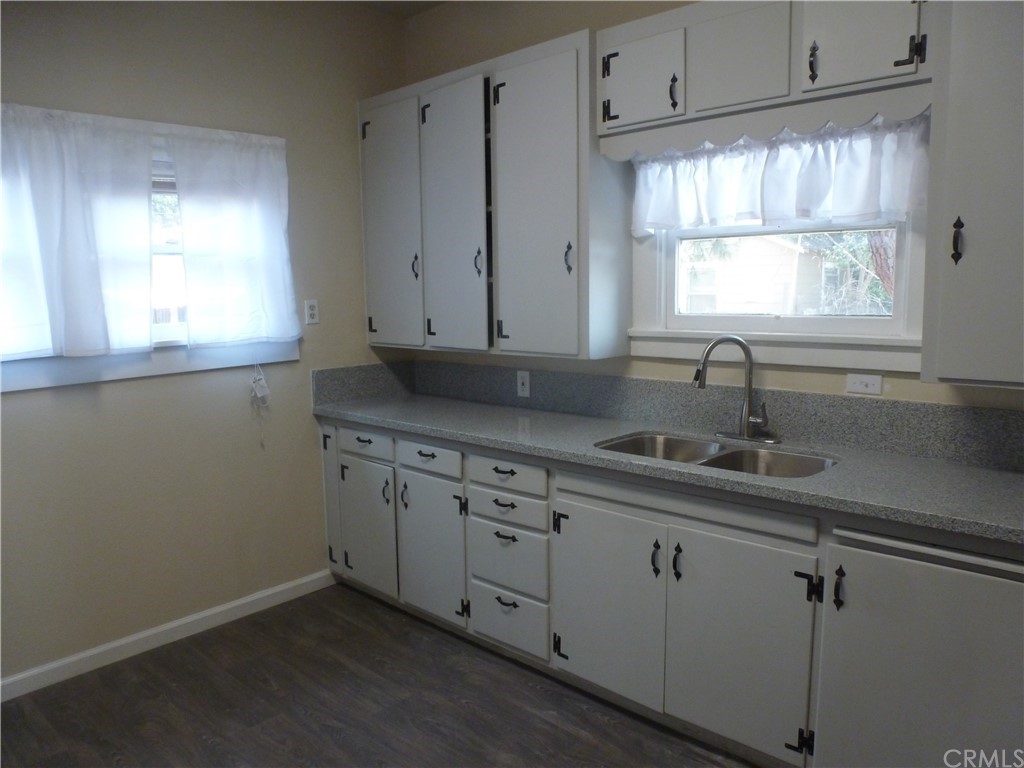1044 West 20th Street Merced, CA 95340 - Photo 5 of 25 a kitchen with stainless steel appliances granite countertop white cabinets and window