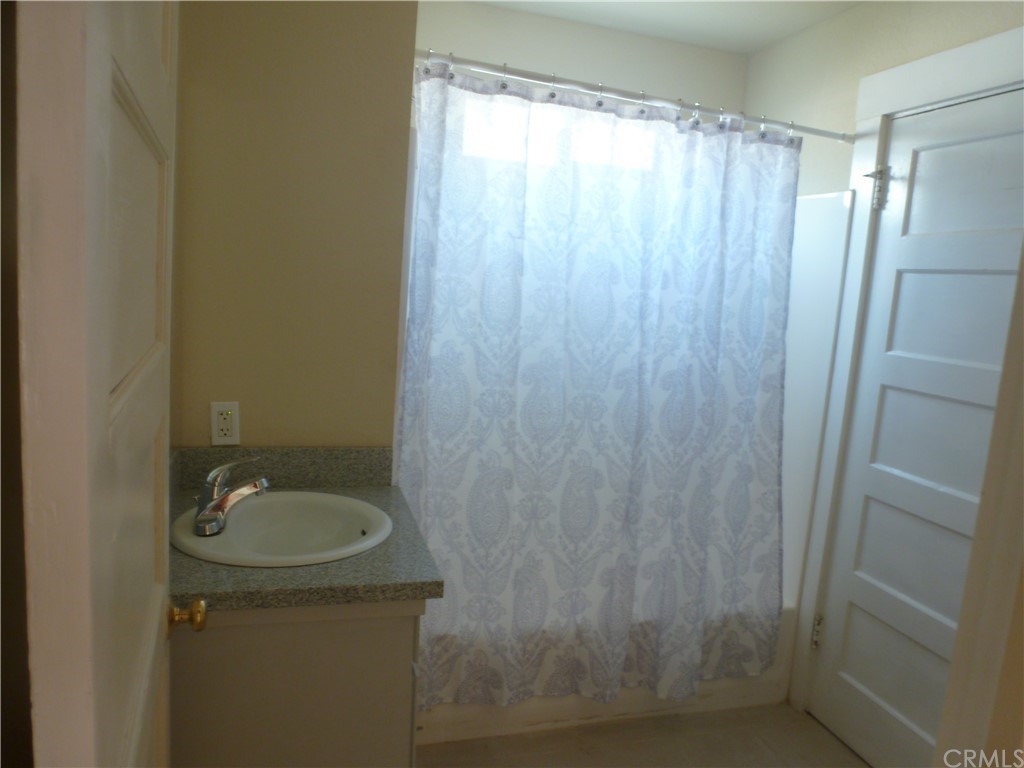 1044 West 20th Street Merced, CA 95340 - Photo 10 of 25 a bathroom with a sink and shower