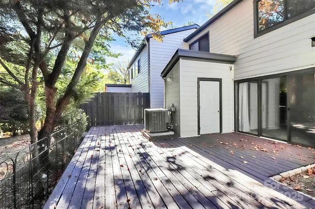 a view of a backyard with a large tree