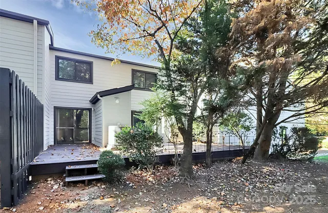 a front view of a house with a tree