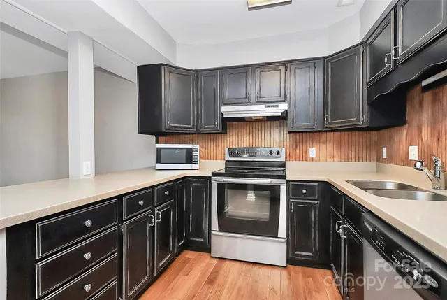 a kitchen with a sink stove and cabinets