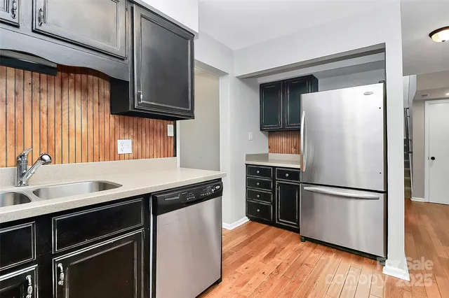 a kitchen with a refrigerator and a sink