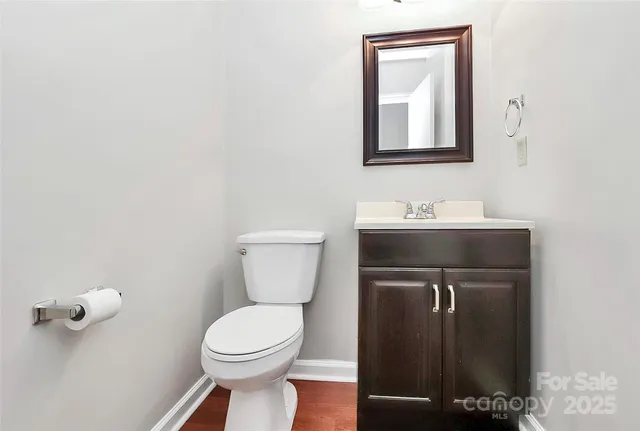 a bathroom with a toilet a sink and mirror
