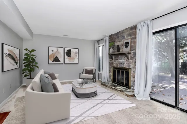 a living room with furniture and a fireplace