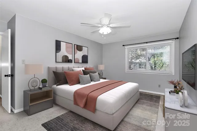 a bedroom with bed and a chandelier