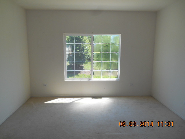 132 Enclave Circle, Unit D Bolingbrook, IL 60440 - Photo 2 of 9 an empty room with a window