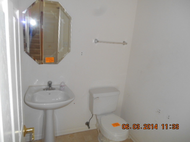 132 Enclave Circle, Unit D Bolingbrook, IL 60440 - Photo 4 of 9 a bathroom with a sink and a mirror